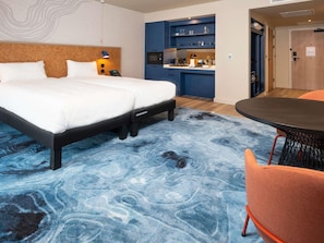 A hotel room with a bed, a desk, a chair, and a kitchenette. - ibis Styles Burton Upon Trent - Hotel & Suites (Burton on Trent)