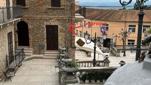 A stone building with a balcony, a staircase, and a view of the sea. - Ferruccio's House - Ground Floor (Colonnella)