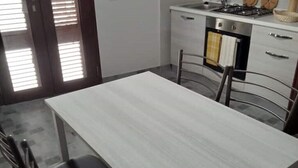 A kitchen with a white countertop, a stove, and a sink. - Ferruccio's House - Ground Floor (Colonnella)