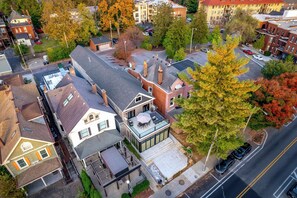 An aerial view of a residential area with houses, trees, and a road.