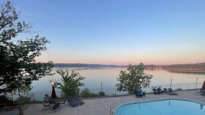 A swimming pool with a view of a lake and trees. - Lakeside Boho Bungalow on Table Rock Lake (Kimberling City)