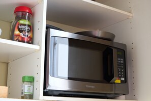 A Toshiba microwave oven on a shelf. - Live the London Movie in Notting Hill (London)