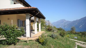 A house with a covered porch, a mountain view, and a clear sky.