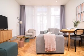 Suite Studio, balcon | Coin séjour | Télévision à écran plat de 50 pouces avec chaînes par câble