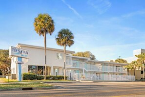A two-story motel with a sign reading 'FIN'S INN' and a 'WELCOME' sign. - Fin's Inn & Suites  (Myrtle Beach)