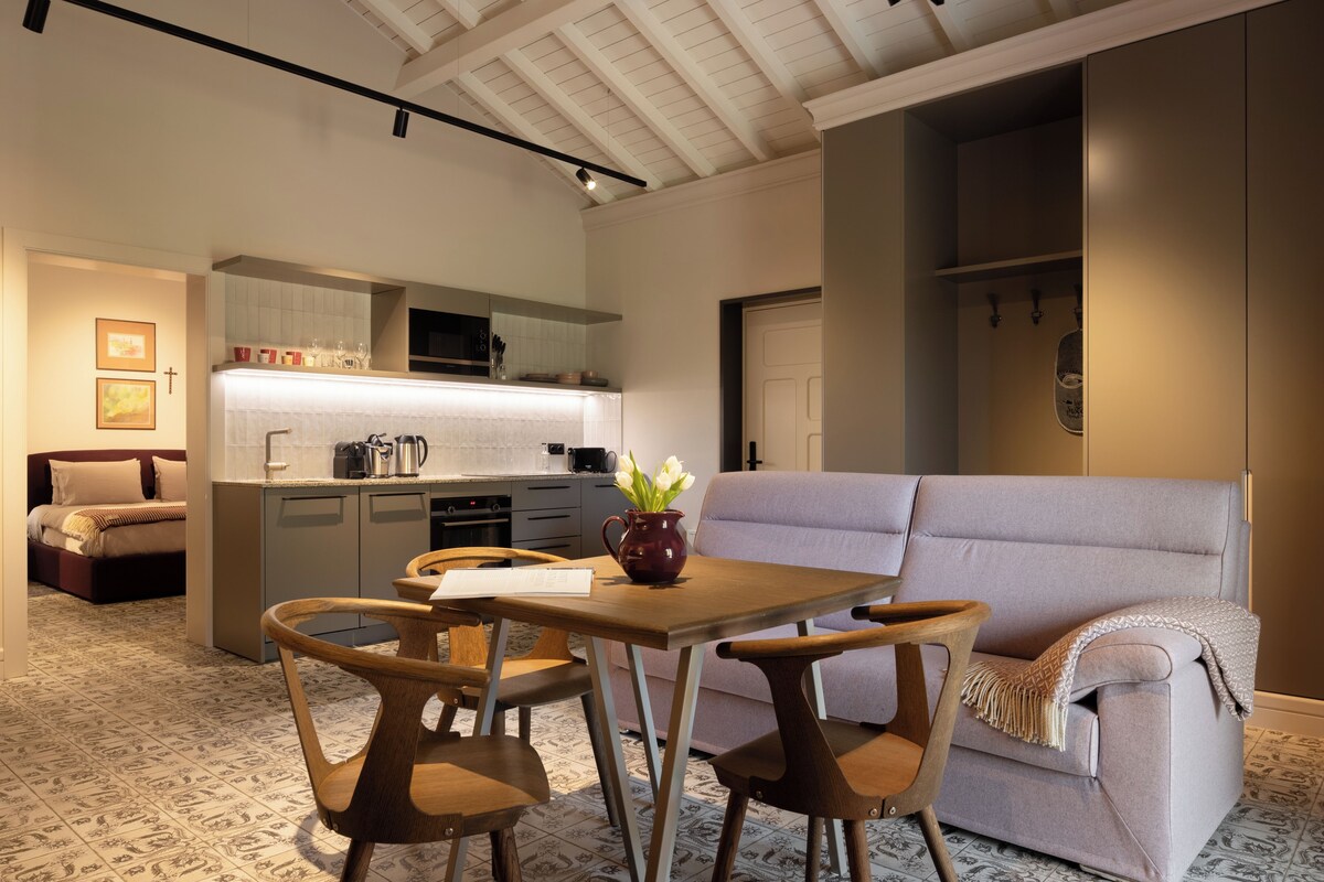 A modern interior with a dining area, kitchen, and seating space.