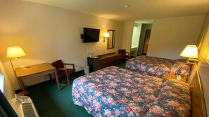 A hotel room with two beds, a desk, a chair, a TV, and a mirror. - Boulder Bear Motor Lodge (Boulder Junction)