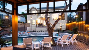 A wooden deck with lounge chairs and a swimming pool.