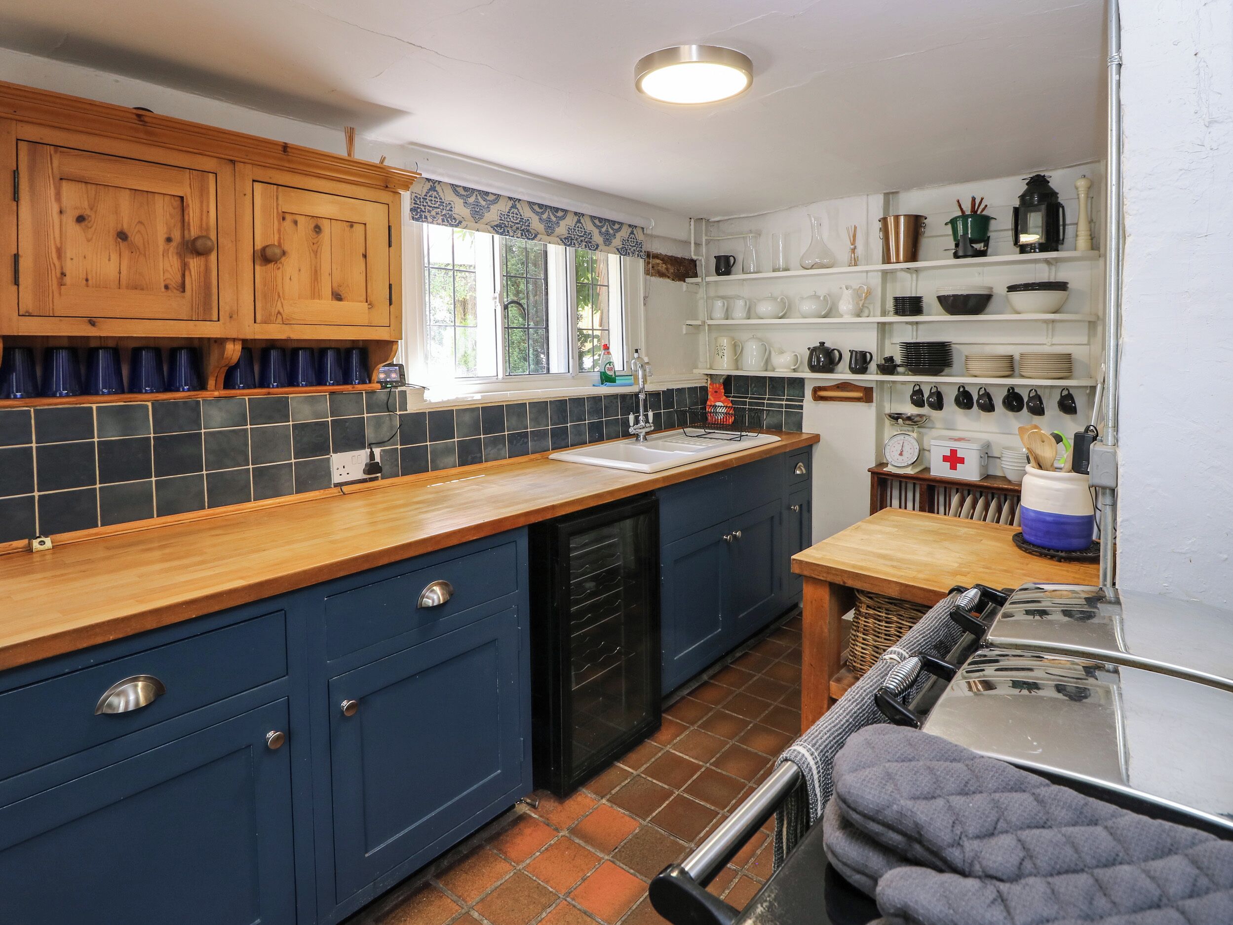 A kitchen with wooden cabinets, a tiled backsplash, and a countertop.