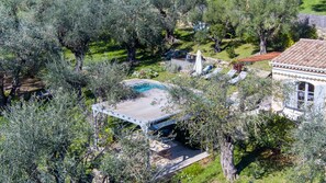 Relax in a serene natural setting with a pool, hot tub, and lush surroundings.