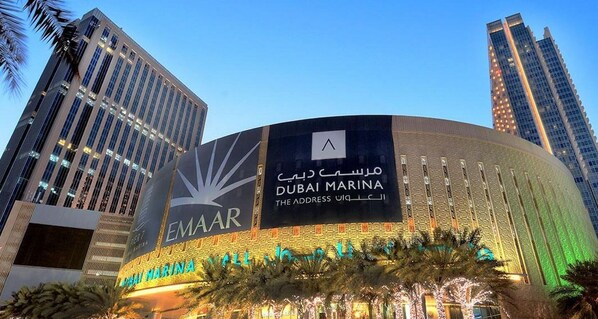 Located in the heart of Dubai Marina, this hotel boasts a striking curved facade and illuminated sign.
