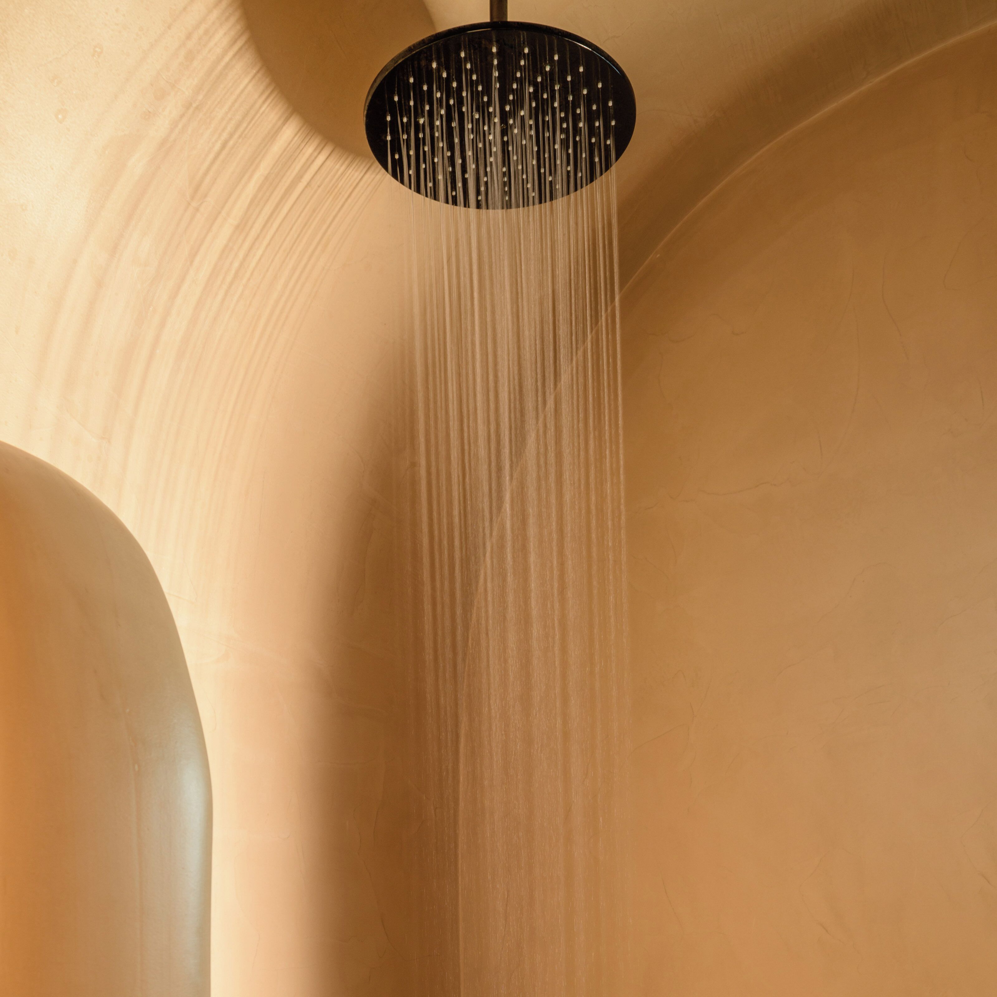 A modern shower with a circular design and multiple water jets.