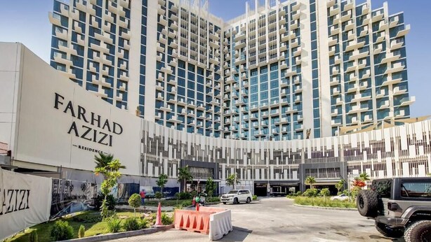 A modern multi-story building with the name "Farhad Azizi Residence" prominently displayed. - Burj Khalifa View Studio in Jeddaf - FAR (Dubai)