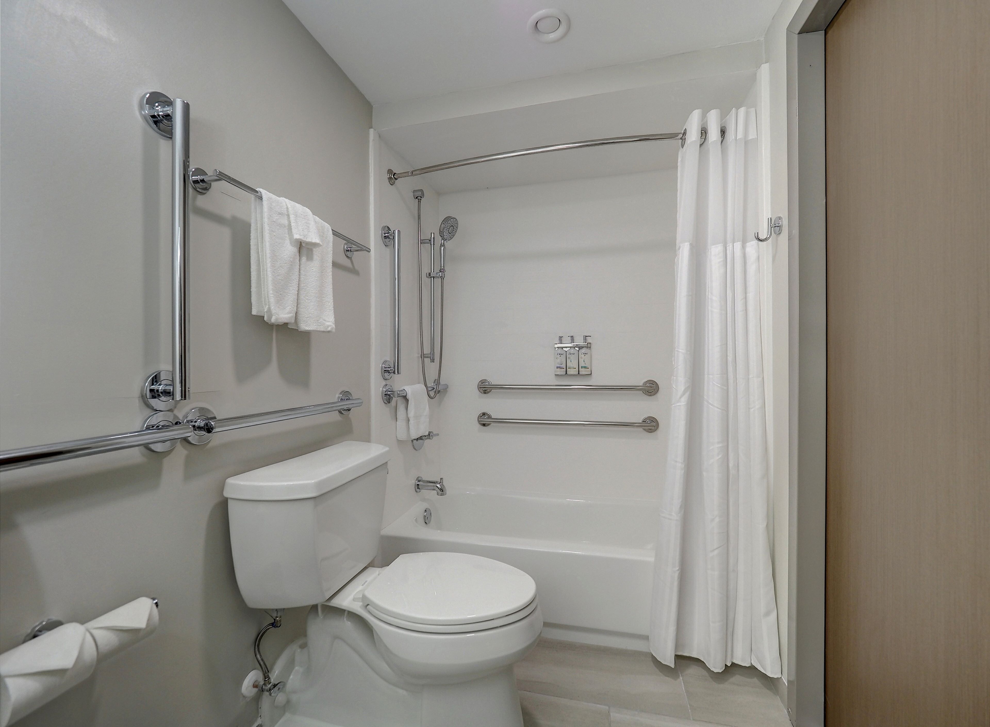 A bathroom with a toilet, a bathtub, and a shower.