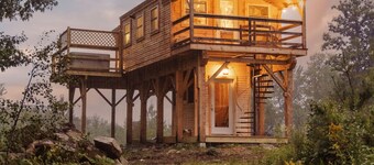Insanely romantic treehouse perched next to a stream and rolling hills.