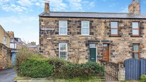 A stone building with multiple windows and a green door, labeled "Victoria Terrace." - 3 bedroom accommodation in Alnwick (Alnwick)