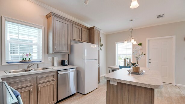 A modern kitchen with wooden cabinets, a built-in dishwasher, and a central island. - New Construction in Venture Out! 3 night minimum stay. (Cudjoe Key)