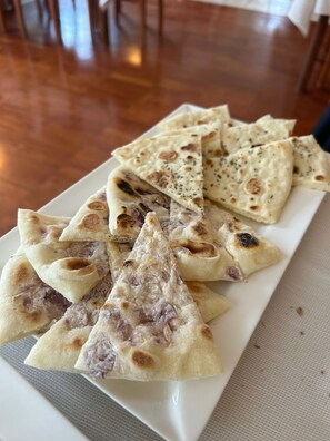 Freshly baked flatbread served on a wooden table.