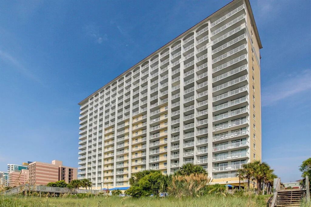 A high-rise building with multiple balconies, likely a hotel or apartment complex.