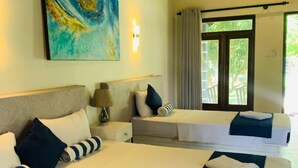 A hotel room with two beds, a painting on the wall, a lamp, and a window with curtains. - Anukama Resort  (Nilaveli)