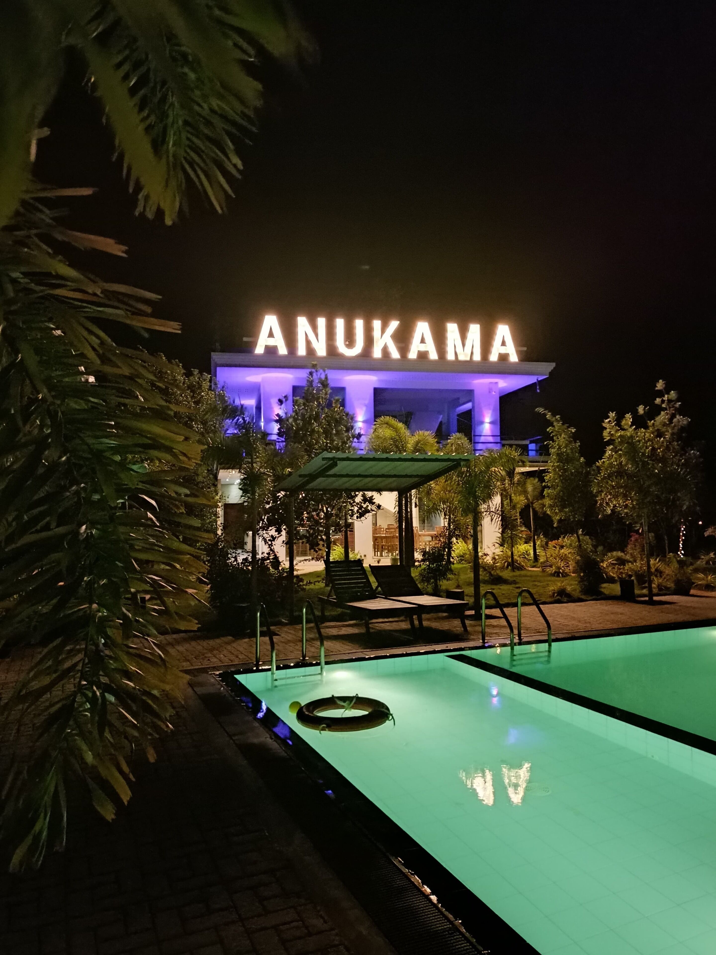 A hotel named Anukama with a swimming pool and lounge chairs.