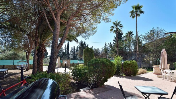 A patio area with outdoor seating, a pool, and various trees. - Villa Immersed in Relaxation 500 Metres From the Sea (Avola)