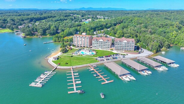 An aerial view of a lakeside hotel with multiple buildings, a marina, and a swimming pool. - Lakefront Condo w/ Free Resort Amenities at SML! (Huddleston)