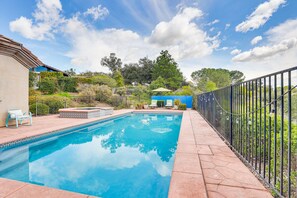 A rectangular swimming pool with a tiled edge, surrounded by a paved deck. - Escondido Home: Private Pool, 2 Grills & Fire Pit! (Escondido)