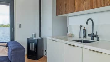 A modern kitchen with a built-in stove, a sink with a modern faucet, and wooden cabinets.