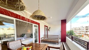 A balcony with a wooden table, a bowl of fruit, and a bench. - VILAMOURA MARINA CHARMING WITH POOL by HOMING (Vilamoura)