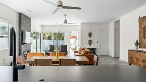 Een moderne keuken met een eethoek, een plafondventilator en uitzicht op de omgeving.