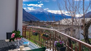 Ein Balkon mit Blick auf Berge und einen See.