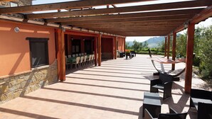 An outdoor patio with a covered seating area, stone walls, and a view of the mountains. - Beautiful private villa with WIFI, private pool, TV, terrace, pets allowed and panoramic view (Trivigno)