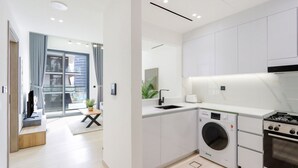 A modern kitchen with a Bosch washing machine, a Bosch stove, and a sink.