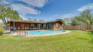 A single-story house with a swimming pool, a patio with a bench, and a wooden fence. - Pet-Friendly San Antonio Vacation Rental w/ Pool! (San Antonio)