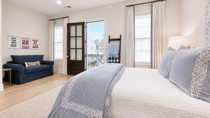 A bedroom with a bed, a sofa, a window with curtains, and a door. - The Nola, 3BR Luxe Stay by Velvet Ditch Villas (Oxford)