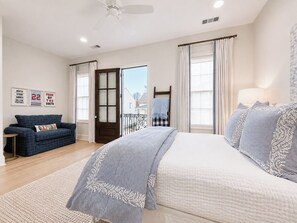 A bedroom with a bed, a sofa, a window with curtains, and a door. - The Nola, 3BR Luxe Stay by Velvet Ditch Villas (Oxford)