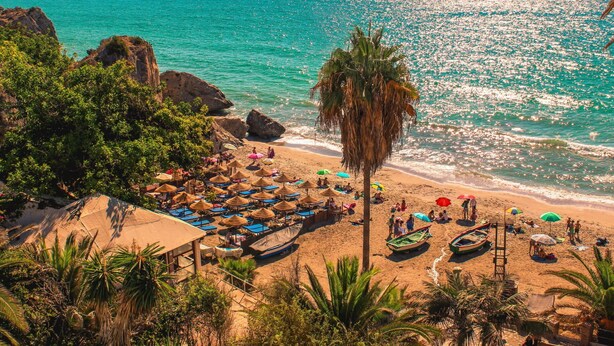 A beach with thatched umbrellas, lounge chairs, and boats. - Stunning private villa for 8 people with A/C, private pool, WIFI, TV and terrace (Frigiliana)