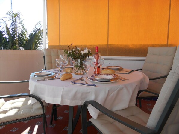 Enjoy a meal at the dining table, set with fine china, wine glasses, and a beautiful floral centerpiece.