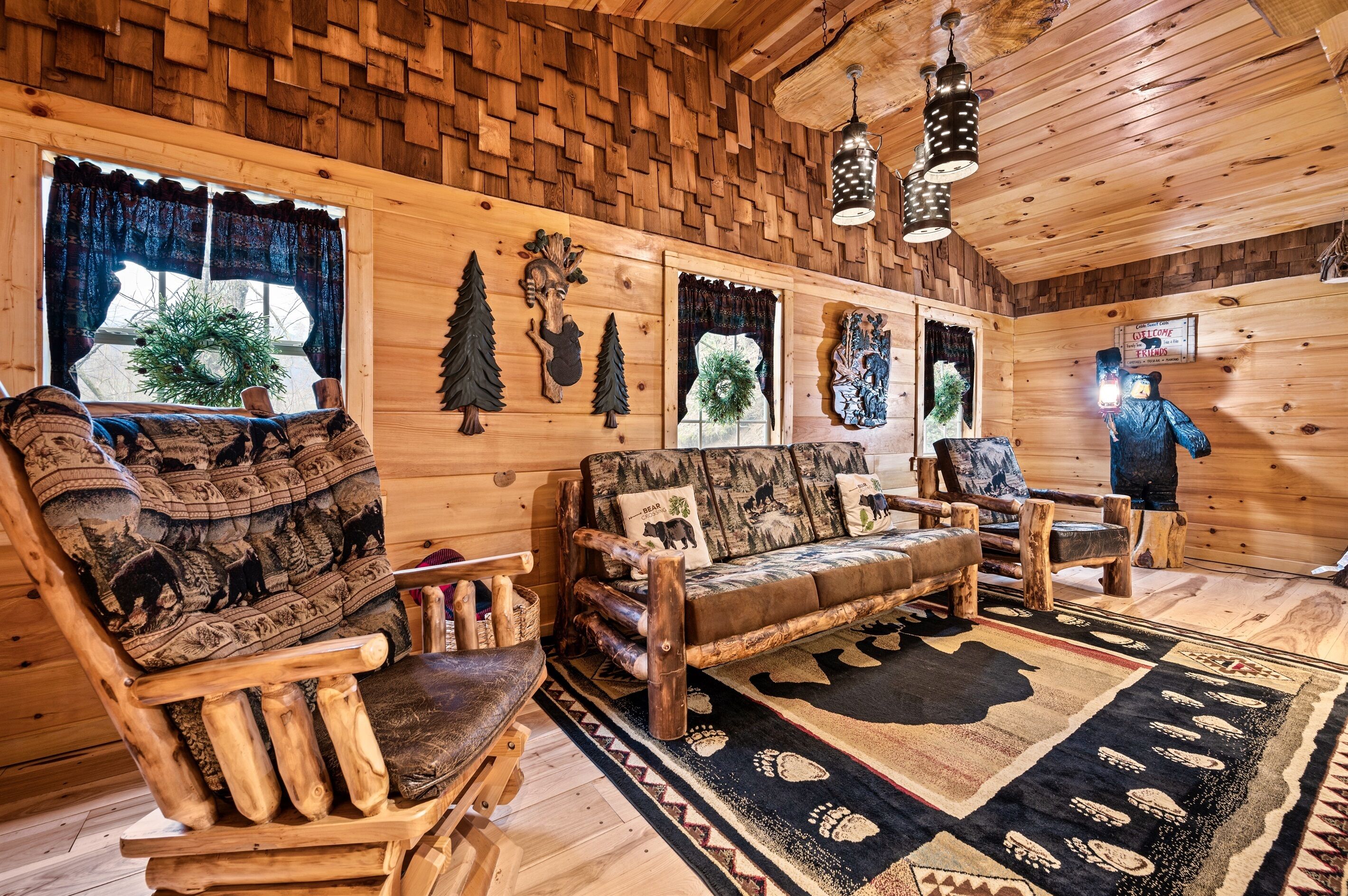 A log cabin interior with a wooden sofa, a wooden chair, and a rug with animal prints.