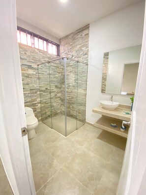 Habitación cuádruple Confort, vista al patio | Baño | Regadera, regadera tipo lluvia, toallas, jabón 