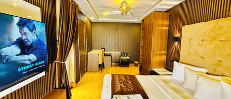A hotel room with a bed, a desk, a television, and a bathroom.