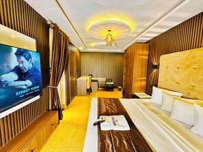 A hotel room with a bed, a desk, a television, and a bathroom. - Presken Hotel Residence  (Lagos)