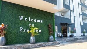 A building with a green wall and a sign that reads 'Welcome to Presten.' - Presken Hotel Residence  (Lagos)