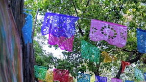 A wooden deck with a pool, surrounded by colorful paper decorations.