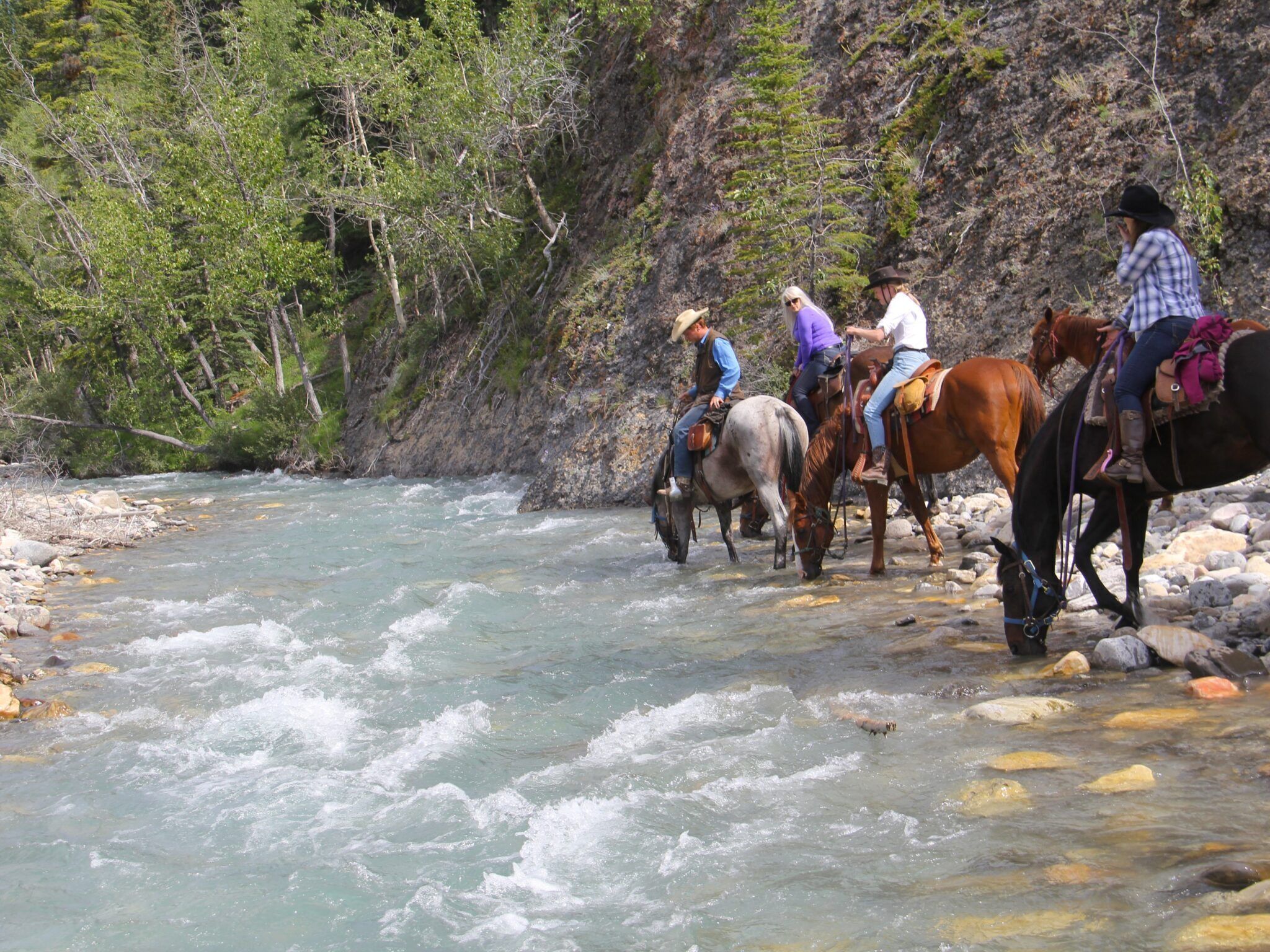 A river with horses and riders.