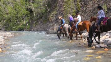 A river with horses and riders.