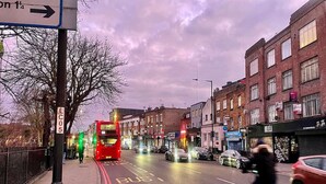 A street scene with a bus stop, buildings, and a cyclist. - Hackney Suites - Triple En-suite Room (G1) (Greater London)