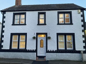 A two-story building with a white exterior and black trim.