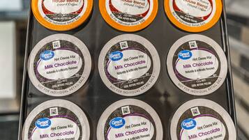 A display of Great Value branded coffee pods in a retail setting.